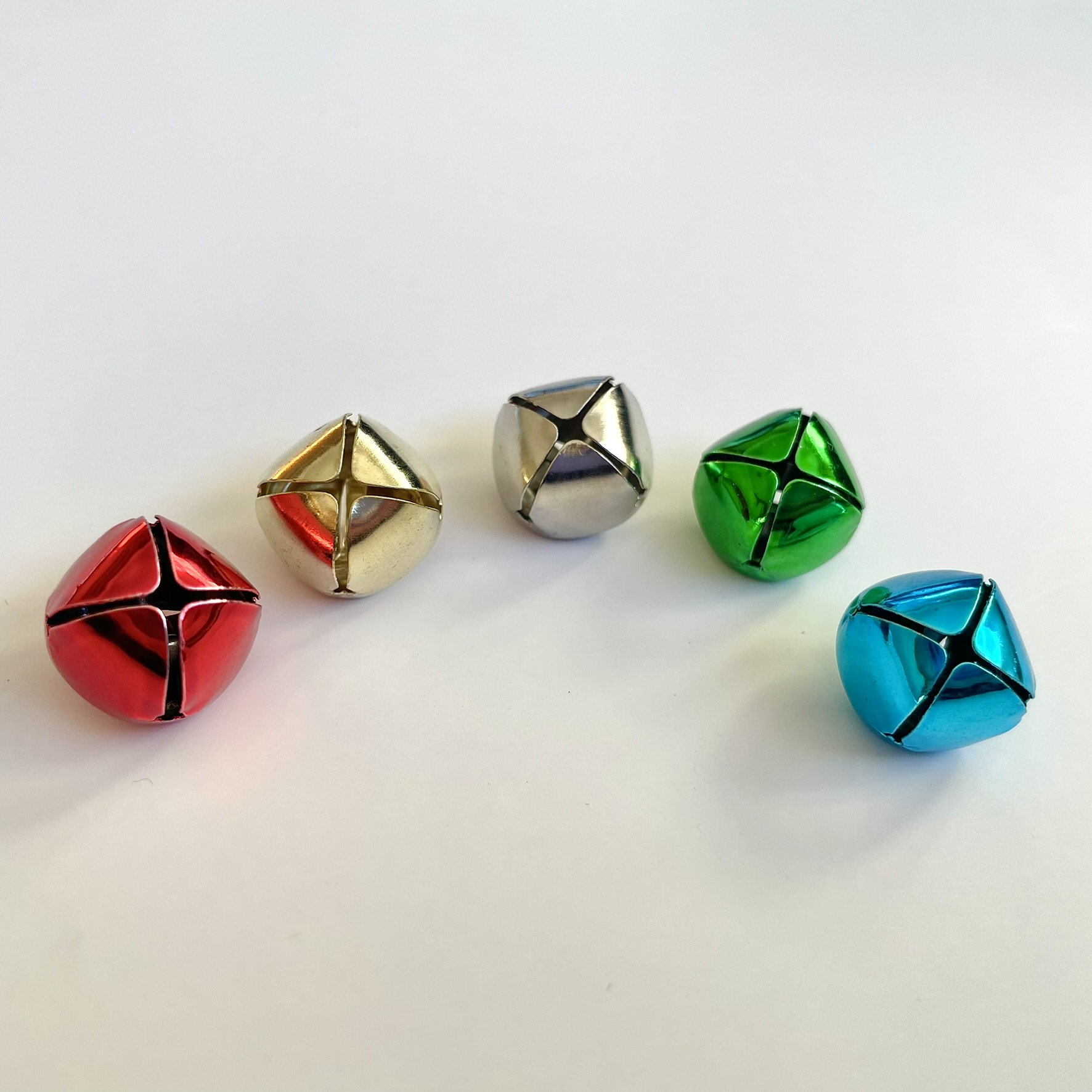 Coloured jingle bells 15mm in length in colours red, blue, green, gold and silver