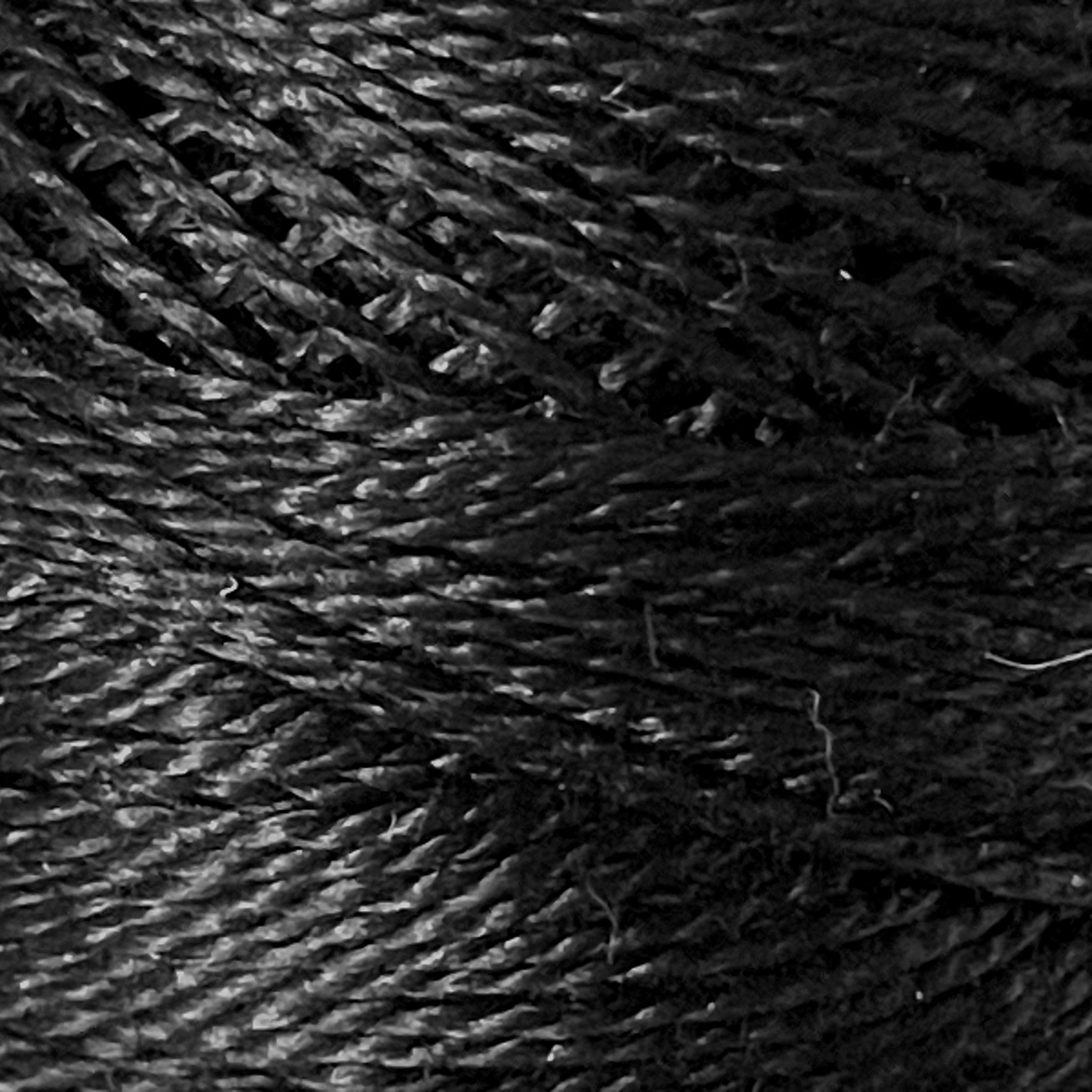 A DMC Cotton Perle 116 / 310 / 8 (Black) ball of 100%, black, mercerised cotton thread that has been manufactured using a twisting process so it iis non-divisible.