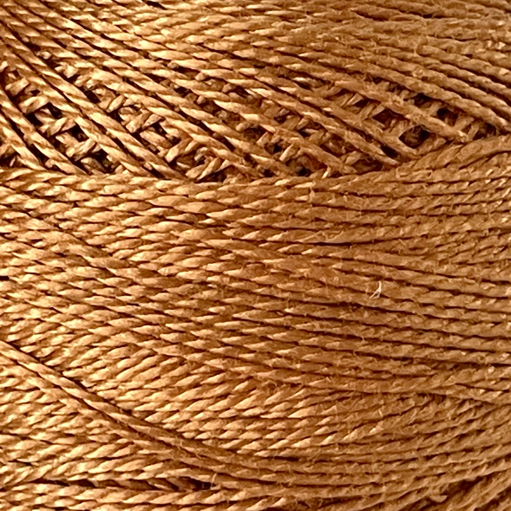 A DMC Cotton Perle 116 / 436 / 8 (Light Tan Brown) ball of 100%, mercerised cotton thread that has been manufactured using a twisting process so it iis non-divisible.
