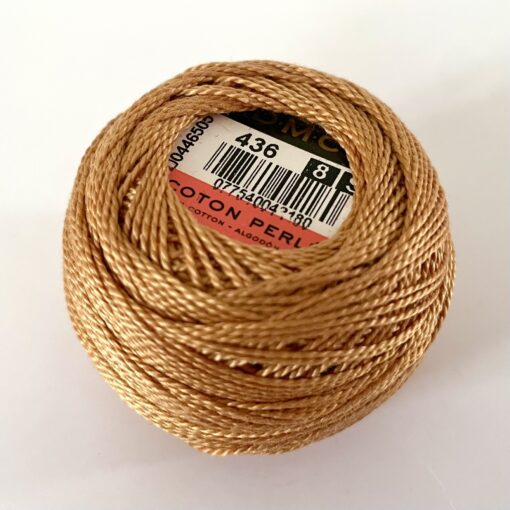 A DMC Cotton Perle 116 / 436 / 8 (Light Brown) ball of 100%, mercerised cotton thread that has been manufactured using a twisting process so it iis non-divisible.