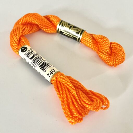 A DMC Cotton Perle in shade 740 (size 3) skein of 100%, mercerised cotton embroidery thread manufactured using a twisting process so it is non-divisible.