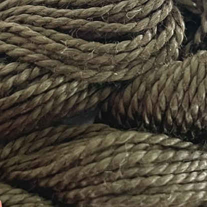 A DMC Cotton Perle in shade 3021 (size 5) skein of 100%, mercerised cotton embroidery thread manufactured using a twisting process so it is non-divisible.