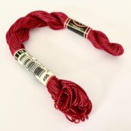 A DMC Cotton Perle in shade 498 (size 3) skein of 100%, mercerised cotton embroidery thread manufactured using a twisting process so it is non-divisible.