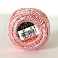 A DMC Cotton Perle 116 / 761/ 5 ball of 100%, pink, mercerised cotton thread that has been manufactured using a twisting process so it is non-divisible.