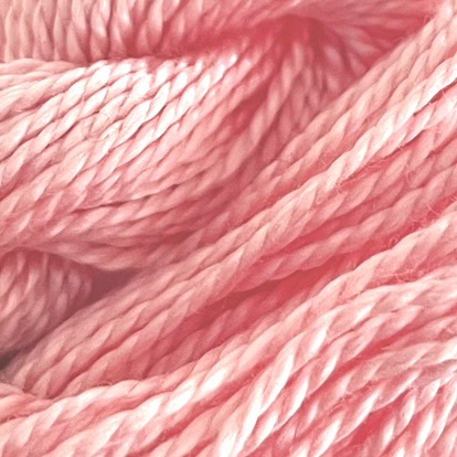 A DMC Cotton Perle in shade 761 (size 5) skein of 100%, mercerised cotton embroidery thread manufactured using a twisting process so it is non-divisible.