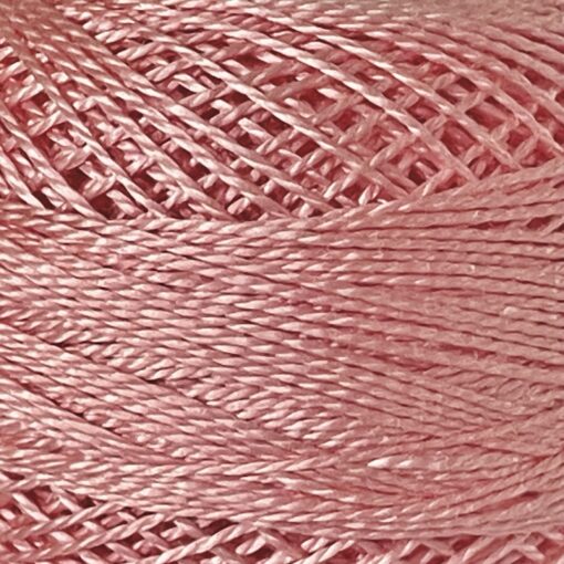 A DMC Cotton Perle 116 / 761/ 8 ball of 100%, pink, mercerised cotton thread that has been manufactured using a twisting process so it is non-divisible.
