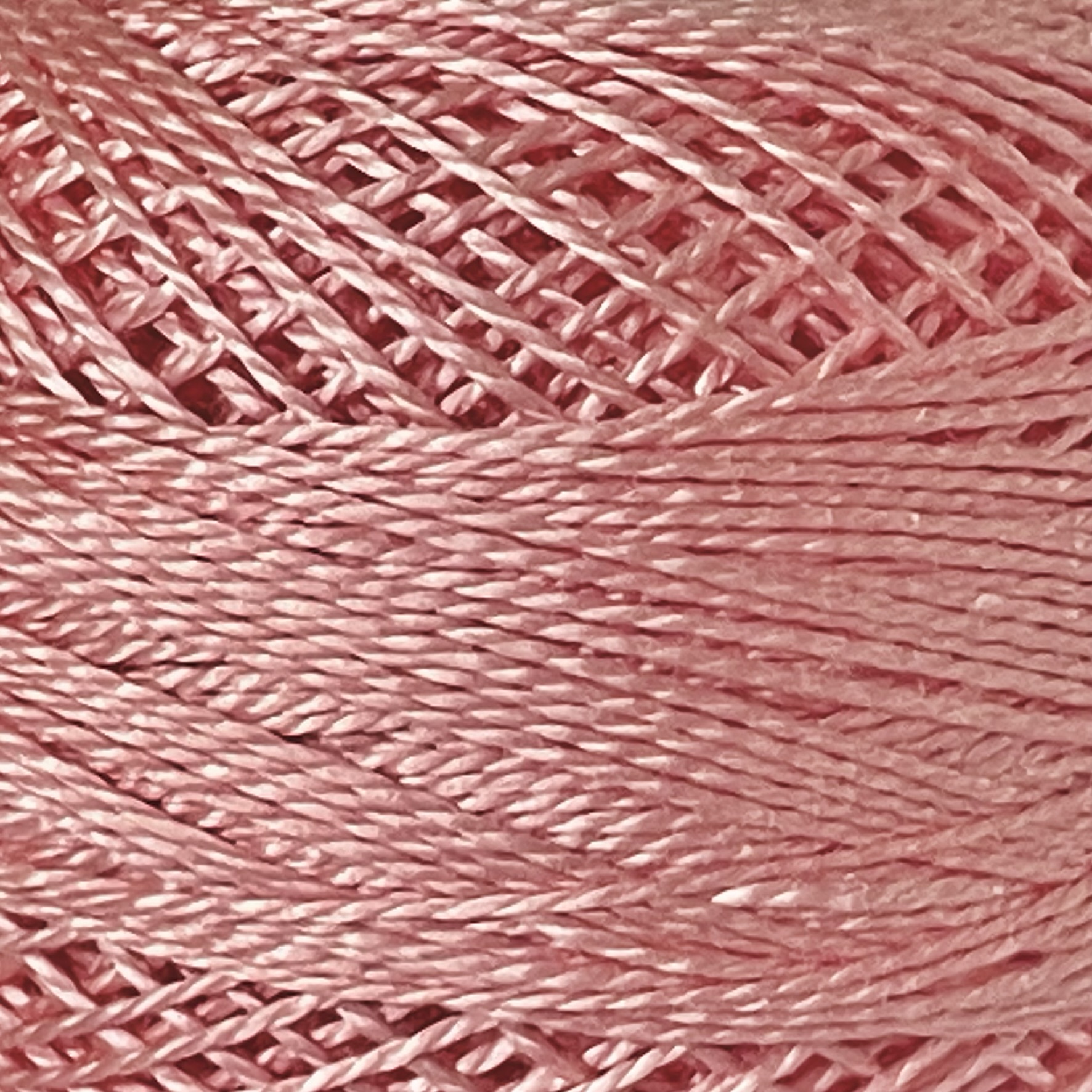 A DMC Cotton Perle 116 / 761/ 8 ball of 100%, pink, mercerised cotton thread that has been manufactured using a twisting process so it is non-divisible.