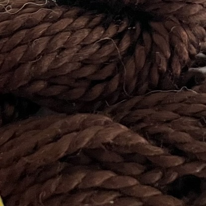 A DMC Cotton Perle in shade 938 (size 3) skein of 100%, mercerised cotton embroidery thread manufactured using a twisting process so it is non-divisible.
