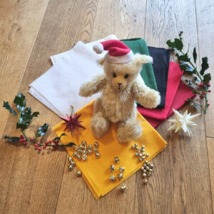 Buttercup mohair teddy bear on Christmas coloured felts