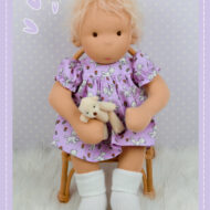 Baby Molly Doll Do Dah Waldorf Style Doll sitting in a chair.